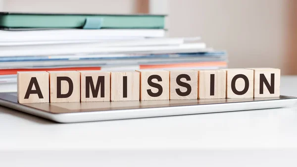 depositphotos_482803198-stock-photo-word-admission-written-wooden-cubes